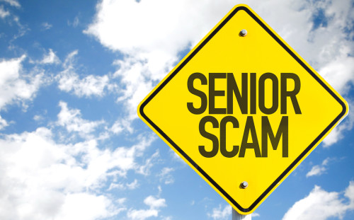 Senior Scam sign with sky background