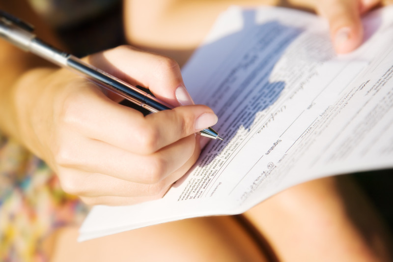 woman signing paperwork for new California Law for home care aids