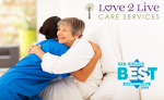 senior caregiver and senior hugging